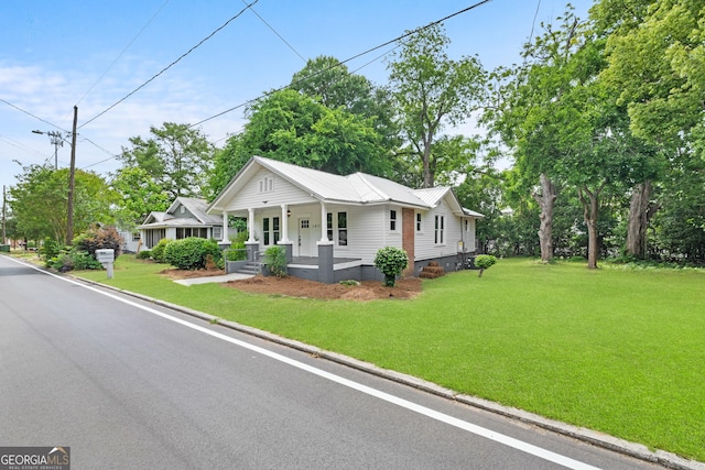 107 S Mulberry St, Statesboro, GA 30458 - view of front of property with covered porch, crawl space, a front yard, and metal roof