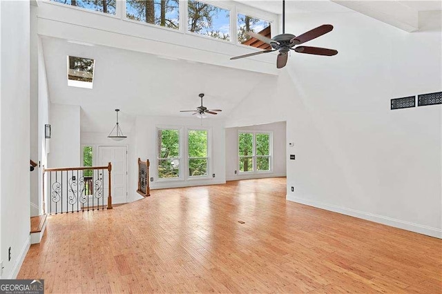 3007 Manning Dr, Marietta, GA 30062 - unfurnished living room featuring high vaulted ceiling, a ceiling fan, wood finished floors, baseboards, and beamed ceiling