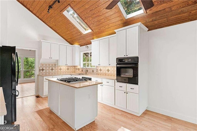 3007 Manning Dr, Marietta, GA 30062 - kitchen with black appliances, a skylight, wood ceiling, vaulted ceiling, and white cabinets