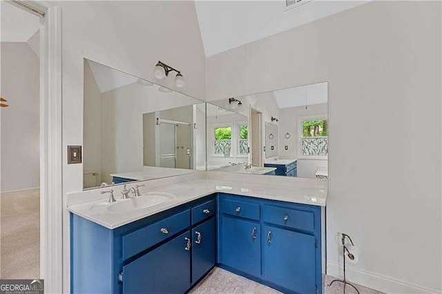 3007 Manning Dr, Marietta, GA 30062 - bathroom featuring lofted ceiling, vanity, a stall shower, and baseboards