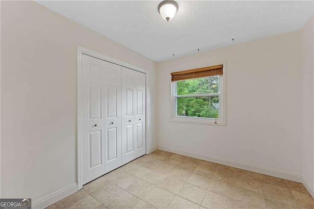 3007 Manning Dr, Marietta, GA 30062 - unfurnished bedroom with baseboards, a closet, and a textured ceiling