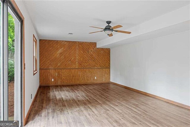 3007 Manning Dr, Marietta, GA 30062 - unfurnished room featuring wood finished floors, wooden walls, ceiling fan, and baseboards
