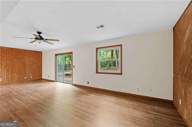 3007 Manning Dr, Marietta, GA 30062 - spare room featuring wood finished floors, ceiling fan, wood walls, and baseboards