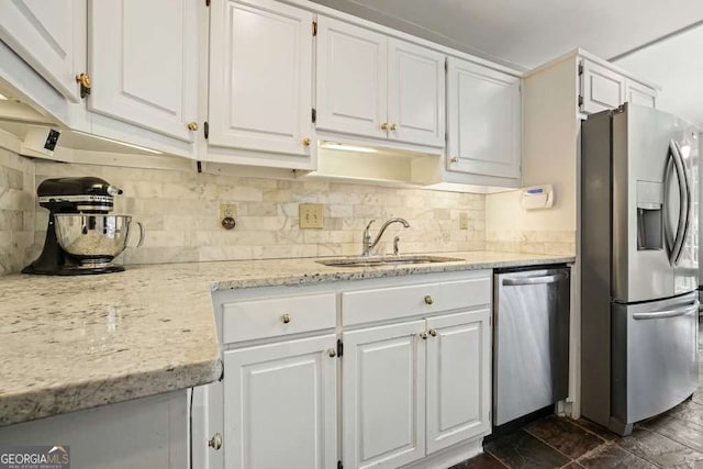 3734 Powers Ferry Rd NW, Atlanta, GA 30342 - kitchen with appliances with stainless steel finishes, a sink, white cabinets, and backsplash