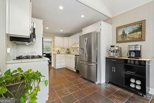 3734 Powers Ferry Rd NW, Atlanta, GA 30342 - kitchen with appliances with stainless steel finishes, white cabinetry, decorative backsplash, crown molding, and recessed lighting
