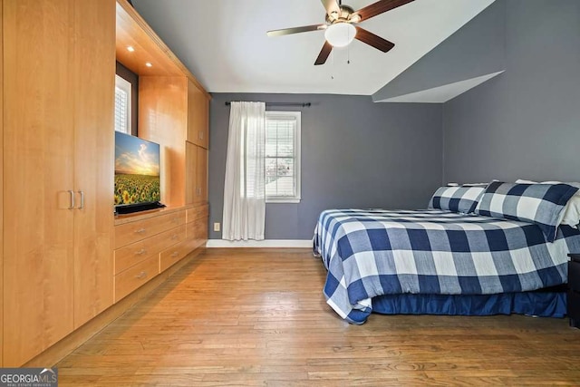 3734 Powers Ferry Rd NW, Atlanta, GA 30342 - bedroom with lofted ceiling, light wood finished floors, multiple windows, baseboards, and a ceiling fan
