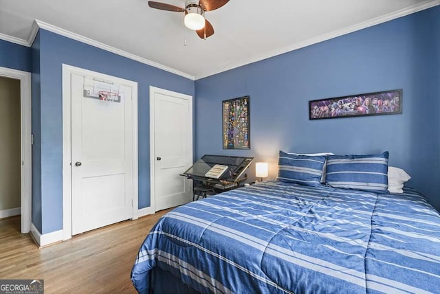 3734 Powers Ferry Rd NW, Atlanta, GA 30342 - bedroom with wood finished floors, crown molding, baseboards, multiple closets, and ceiling fan