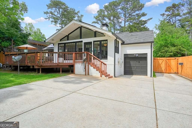 3734 Powers Ferry Rd NW, Atlanta, GA 30342 - view of front of home featuring concrete driveway, an attached garage, a gate, brick siding, and a chimney