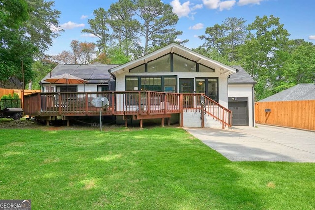 3734 Powers Ferry Rd NW, Atlanta, GA 30342 - rear view of house with concrete driveway, a wooden deck, and a garage