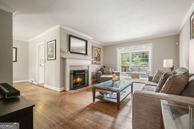 3734 Powers Ferry Rd NW, Atlanta, GA 30342 - living room featuring wood-type flooring, ornamental molding, a fireplace with flush hearth, and baseboards