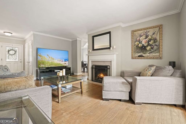 3734 Powers Ferry Rd NW, Atlanta, GA 30342 - living room with crown molding, light wood-style floors, a lit fireplace, and baseboards
