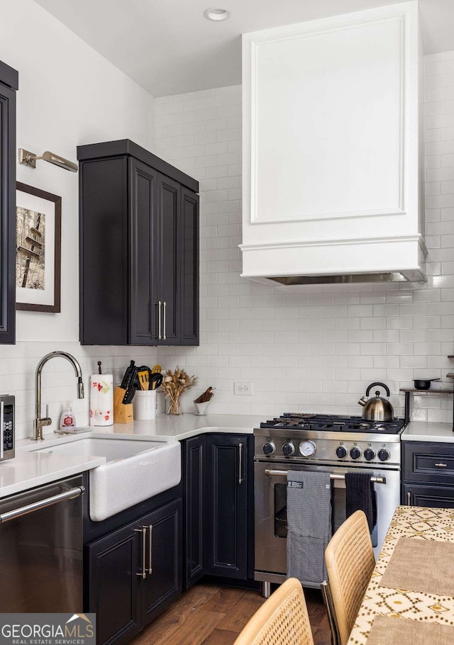 135 Mado Ln, Chattahoochee Hills, GA 30268 - kitchen with stainless steel appliances, light countertops, decorative backsplash, and dark wood-style floors