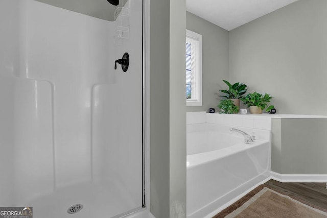 507 Hillcrest Cross Rd, Canton, GA 30115 - bathroom featuring a stall shower, wood finished floors, and a garden tub