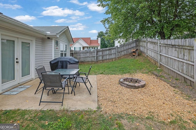 507 Hillcrest Cross Rd, Canton, GA 30115 - fenced backyard with a fire pit, french doors, a patio, and a grill