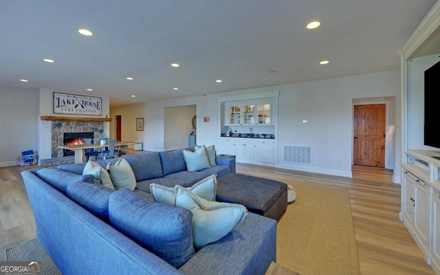1951 Island View Dr, Hiawassee, GA 30546 - living room with light wood finished floors, recessed lighting, a fireplace, baseboards, and bar