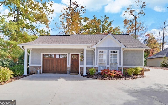 1951 Island View Dr, Hiawassee, GA 30546 - view of front of house featuring driveway, a garage, stone siding, and roof with shingles