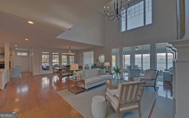 1951 Island View Dr, Hiawassee, GA 30546 - living area with a chandelier, recessed lighting, wood finished floors, a water view, and a high ceiling