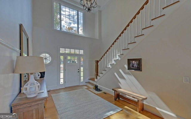 1951 Island View Dr, Hiawassee, GA 30546 - entrance foyer featuring a high ceiling, stairs, a chandelier, and wood finished floors