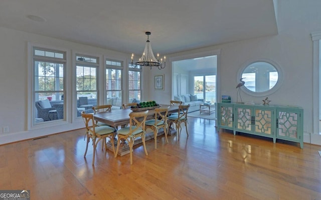 1951 Island View Dr, Hiawassee, GA 30546 - dining room with a chandelier, wood finished floors, and baseboards
