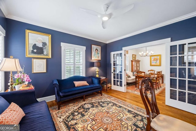 555 Red Bluff Dr, Athens, GA 30607 - living room with wood finished floors, a ceiling fan, ornamental molding, a chandelier, and french doors