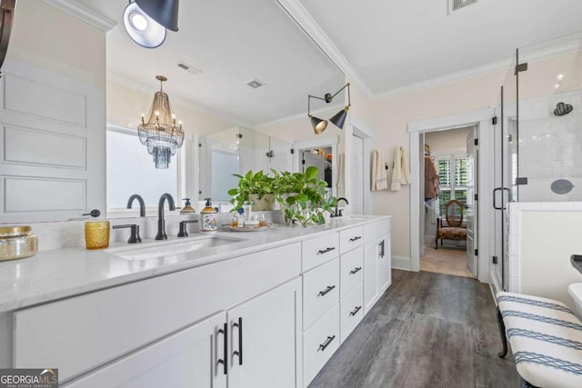 555 Red Bluff Dr, Athens, GA 30607 - full bath with ornamental molding, double vanity, wood finished floors, a shower stall, and a chandelier