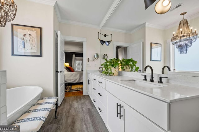 555 Red Bluff Dr, Athens, GA 30607 - ensuite bathroom with a chandelier, wood finished floors, vanity, a soaking tub, and crown molding