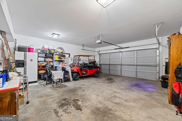 555 Red Bluff Dr, Athens, GA 30607 - garage with white fridge with ice dispenser and a garage door opener
