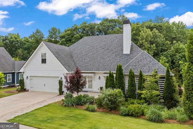 555 Red Bluff Dr, Athens, GA 30607 - view of front of home featuring a front yard, concrete driveway, a chimney, an attached garage, and roof with shingles