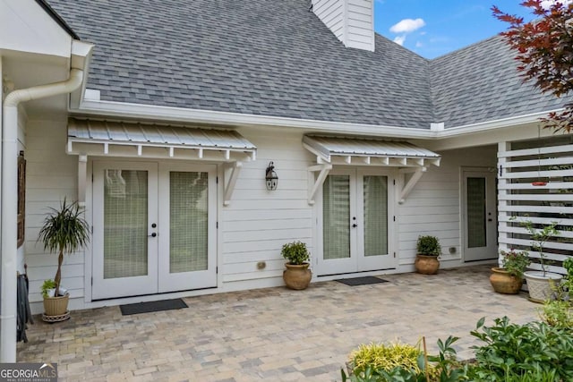 555 Red Bluff Dr, Athens, GA 30607 - property entrance featuring french doors, a shingled roof, a patio area, and a chimney