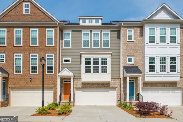 996 Layton Dr, Buford, GA 30518 - view of property featuring a garage, driveway, and brick siding