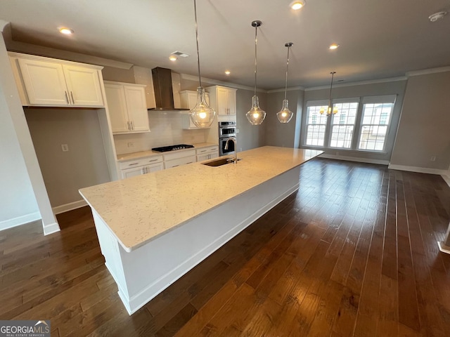 996 Layton Dr, Buford, GA 30518 - kitchen featuring wall chimney range hood, black gas stovetop, a spacious island, white cabinetry, and stainless steel double oven
