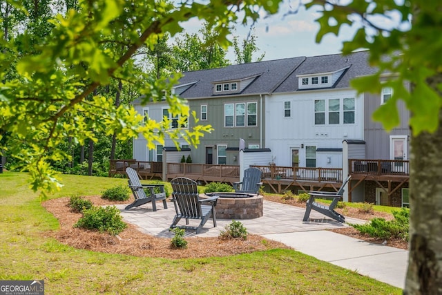 996 Layton Dr, Buford, GA 30518 - back of house featuring an outdoor fire pit, a patio, a deck, a lawn, and board and batten siding