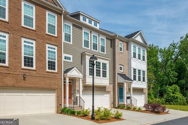 996 Layton Dr, Buford, GA 30518 - multi unit property featuring concrete driveway, a garage, and brick siding