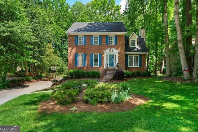 1769 Milford Creek Cts SW, Marietta, GA 30008 - view of front facade featuring a front yard, brick siding, and a chimney