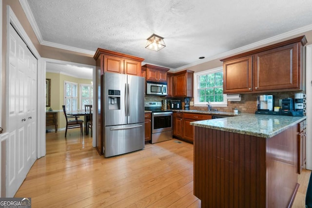 1769 Milford Creek Cts SW, Marietta, GA 30008 - kitchen featuring appliances with stainless steel finishes, a peninsula, backsplash, light wood finished floors, and stone countertops