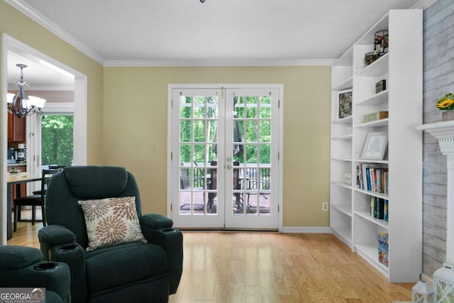 1769 Milford Creek Cts SW, Marietta, GA 30008 - sitting room with light wood-type flooring, french doors, a chandelier, ornamental molding, and a brick fireplace