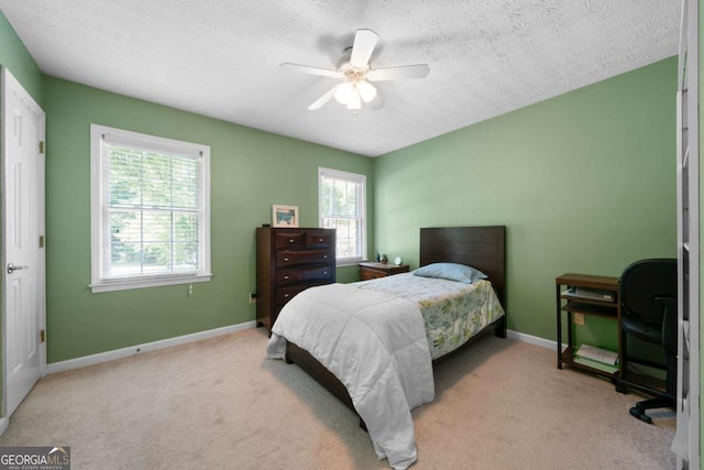 1769 Milford Creek Cts SW, Marietta, GA 30008 - carpeted bedroom with multiple windows, baseboards, a textured ceiling, and ceiling fan