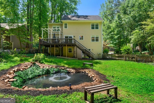 1769 Milford Creek Cts SW, Marietta, GA 30008 - rear view of house with a garden pond, a wooden deck, and stairway