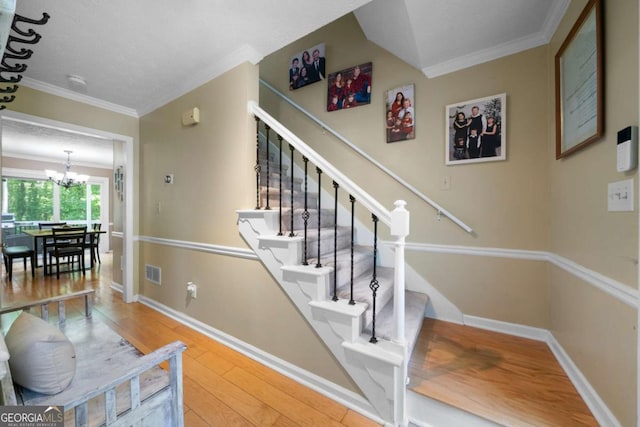 1769 Milford Creek Cts SW, Marietta, GA 30008 - staircase with a chandelier, wood finished floors, crown molding, and baseboards