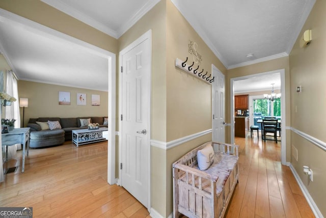 1769 Milford Creek Cts SW, Marietta, GA 30008 - hall with light wood-type flooring, a chandelier, and ornamental molding