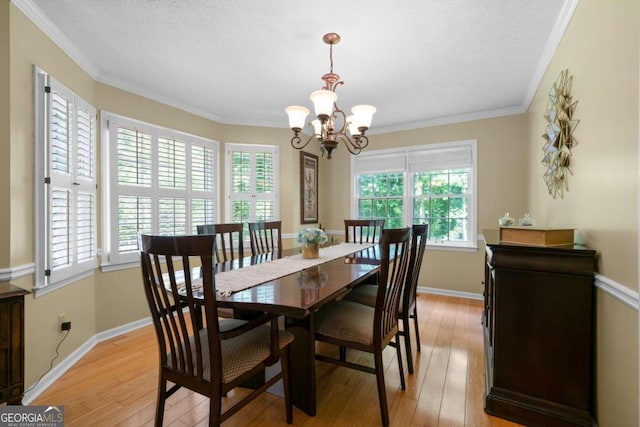 1769 Milford Creek Cts SW, Marietta, GA 30008 - dining area featuring healthy amount of natural light, a chandelier, light wood-type flooring, crown molding, and a textured ceiling