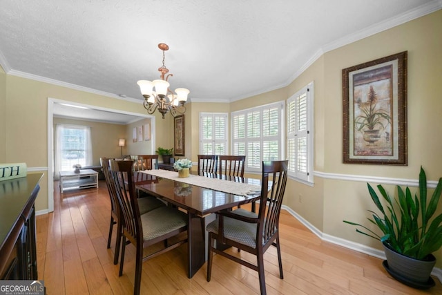 1769 Milford Creek Cts SW, Marietta, GA 30008 - dining area featuring plenty of natural light, a chandelier, light wood-style floors, and ornamental molding