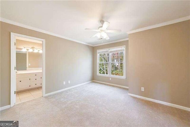 1021 Oakpointe Pl, Dunwoody, GA 30338 - unfurnished bedroom featuring light carpet, crown molding, connected bathroom, and a ceiling fan