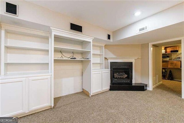 1021 Oakpointe Pl, Dunwoody, GA 30338 - unfurnished living room featuring light colored carpet, a fireplace with raised hearth, and recessed lighting