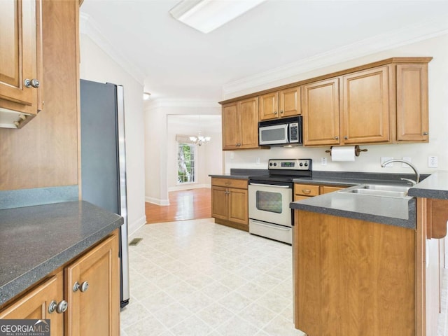 1090 Lane Creek Cir, Bishop, GA 30621 - kitchen with appliances with stainless steel finishes, crown molding, dark countertops, brown cabinetry, and a chandelier