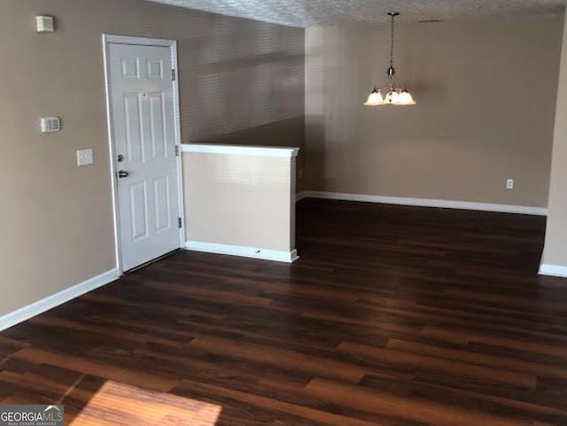 18101 Waldrop Cv, Decatur, GA 30034 - unfurnished dining area featuring wood finished floors, a chandelier, baseboards, and a textured ceiling