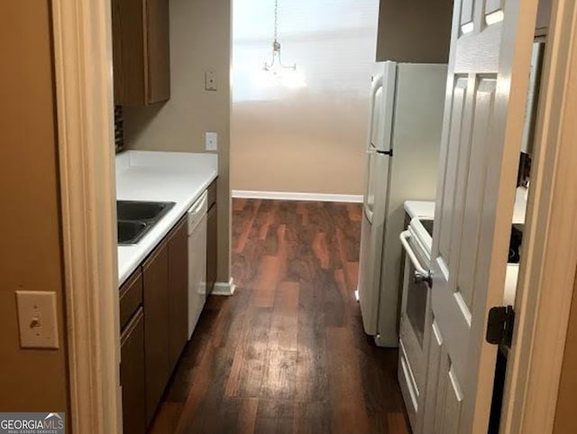 18101 Waldrop Cv, Decatur, GA 30034 - kitchen with a sink, dark wood finished floors, light countertops, a chandelier, and range