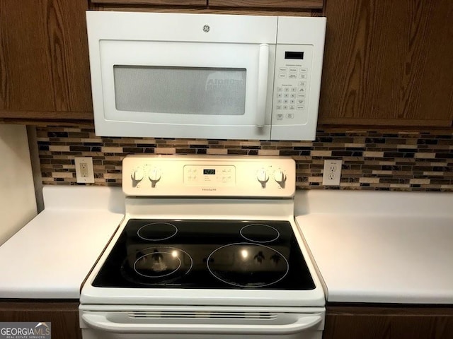 18101 Waldrop Cv, Decatur, GA 30034 - kitchen view of white appliances, tasteful backsplash, dark brown cabinets, and light countertops
