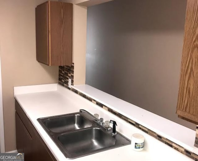 18101 Waldrop Cv, Decatur, GA 30034 - kitchen view of a sink, light countertops, and brown cabinets