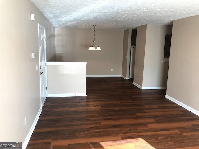 18101 Waldrop Cv, Decatur, GA 30034 - spare room with a chandelier, dark wood-style flooring, a textured ceiling, and baseboards